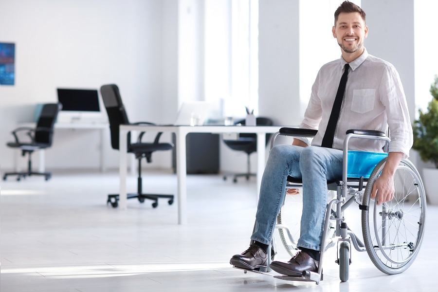 Person in Wheelchair in Office|Person Filling Out Forms