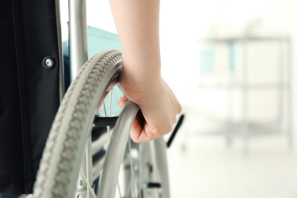 Wheelchair|Woman Looking at Benefits Online