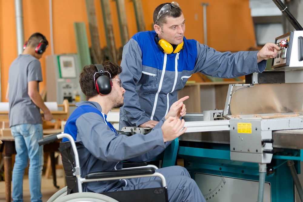 Disabled worker in factory|Worker with prosthetic leg