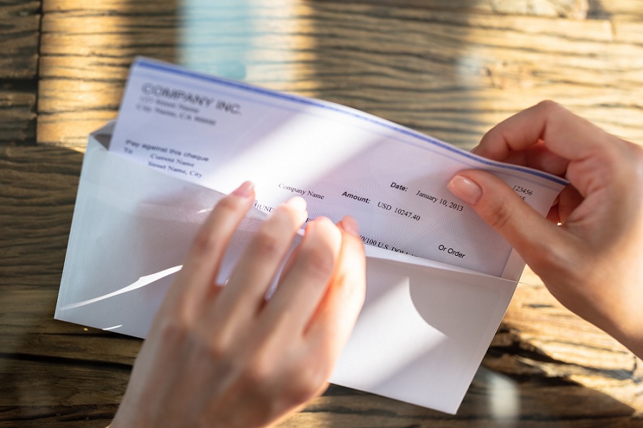 Opening Envelope with Paycheck