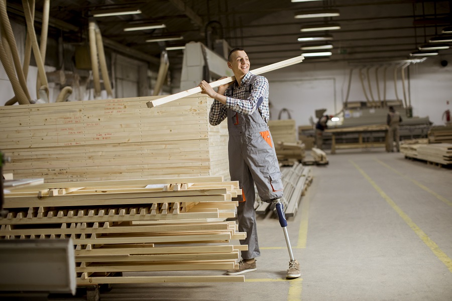 Man with prosthetic leg working in warehouse