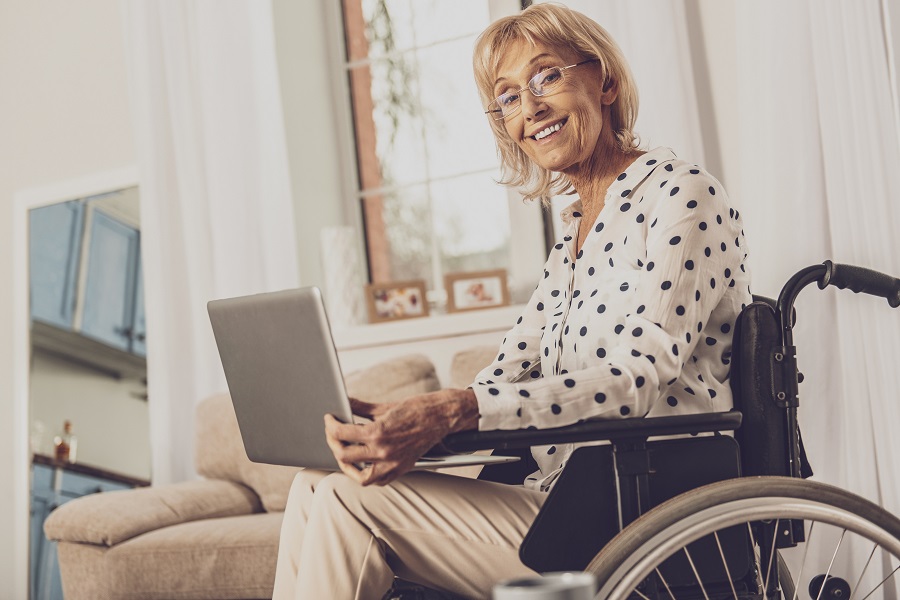 Elderly Lady in Wheelchair Working on Laptop|Social Security Disability Form