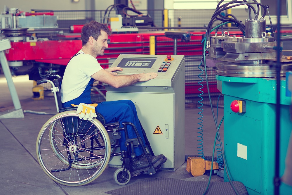 Man in Wheelchair Working in Factory